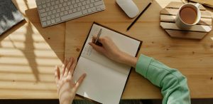 Student sitting at desk writing in notebook