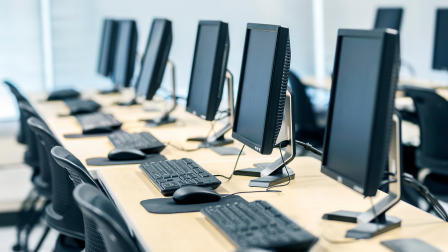 Exam room with desks of computers prepared for online exams