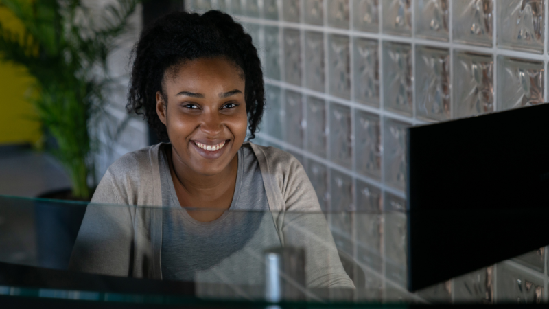 Women sitting behind a desk working as a receptionist.