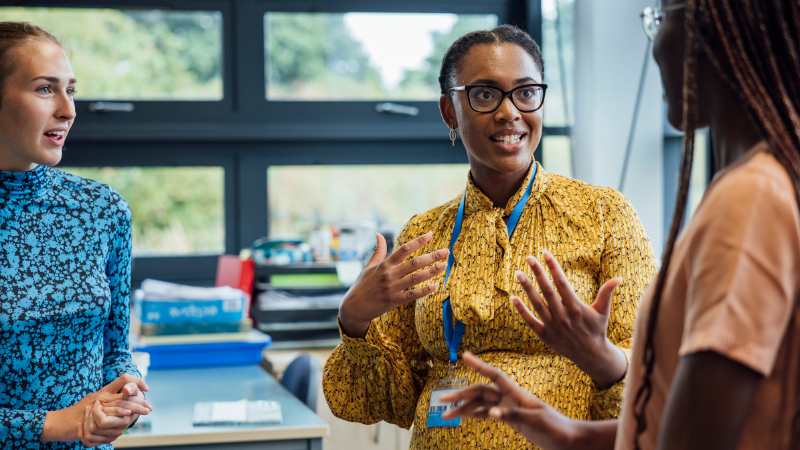 Lady assessing two other women in a workplace